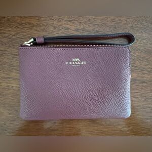 NWOT maroon authentic Coach wristlet. Never used.